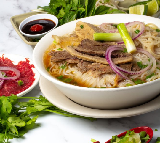 Pho bowl with noodles and herbs